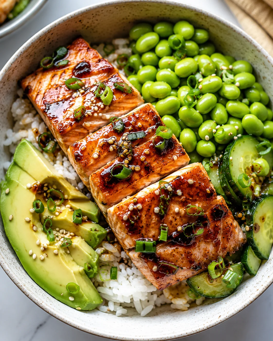 Soy honey glazed salmon bowl with edamame and rice